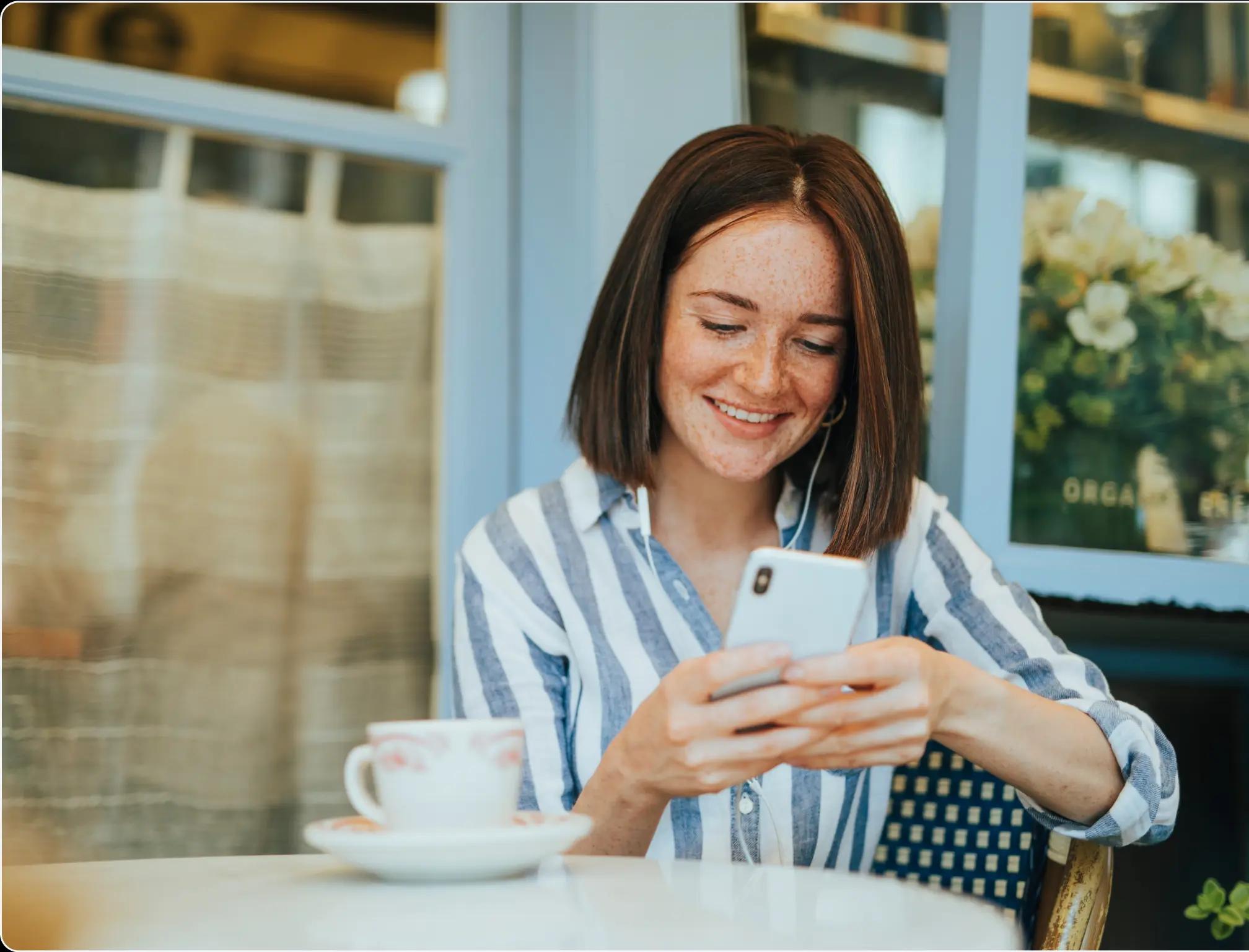 woman with a cellphone and coffee