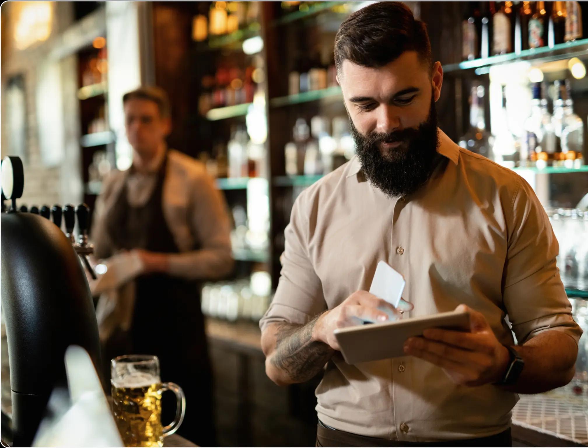 a man with a tablet and a waiter